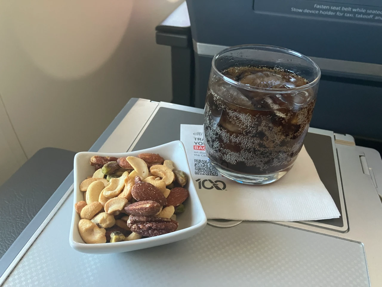Warmed nuts and a drink in AA first class