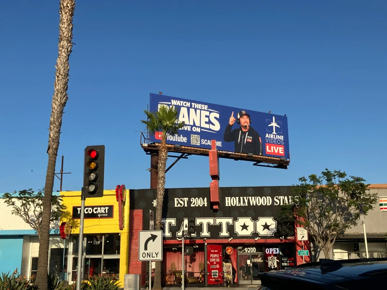 The Airline Videos Live billboard and Taco Cart in front of the LAX In-N-Out